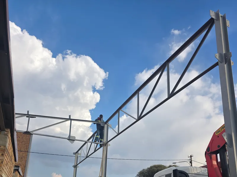 Crane truck lifting a truss into place